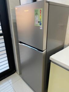 a stainless steel refrigerator in a kitchen at The Chen Story in Jincheng
