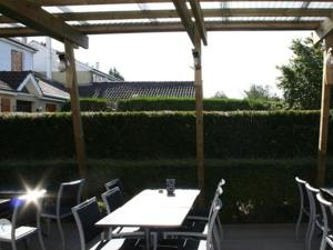 a table and chairs under a pergola on a patio at Storia Da Ennio in La Verrière