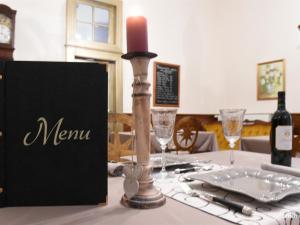 a candle sitting on top of a table with a table cloth at Le Château d'Orleix in Orleix