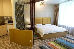 a bedroom with a bed and a large window at Seven Eleven Apartment HOTEL in Most City in Dnipro