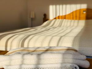 a bed with white towels laying on it at Francesco's Mountain Apartment in Predeal
