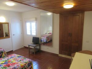 a bedroom with a mirror and a bed and a desk at Vista Playa in Mogán