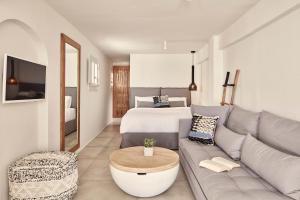 a living room with a couch and a bed at Boho Suites in Mýkonos City