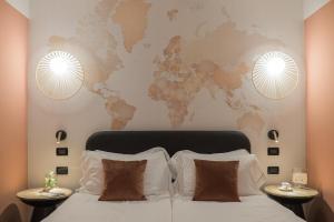 a bedroom with a bed with a world map on the wall at Hotel Luise in Riva del Garda