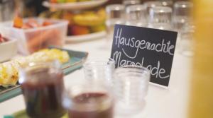 a table with glasses of food and a sign on it at Garni Brunnenhof in Caldaro