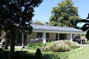 a house with a solar roof on it at TAMO Guest Farm in Plettenberg Bay