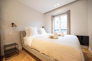 a bedroom with a large bed with a window at Luxury apartments in Paris Center in Paris +3 photos