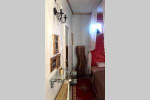 a small room with a bed and a hallway at Romantic Studio Apartment in the heart of the city in Komárom