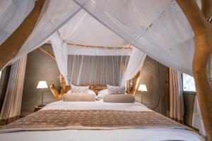 a bedroom with a bed with a canopy at Leopard Safaris Yala in Yala