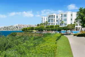 a view of a large apartment building and the water at Xanadu Island in Akyarlar