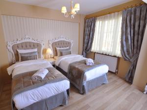 Postel nebo postele na pokoji v ubytování Divani Ali Hotel