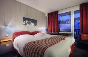 Ένα ή περισσότερα κρεβάτια σε δωμάτιο στο Hotel Le Val Chavière