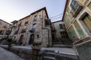an old stone building with stairs in an alley at San Giuseppe in Nicotera