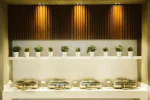 a row of pots on shelves with plants at Pyramisa Suites Hotel Cairo in Cairo