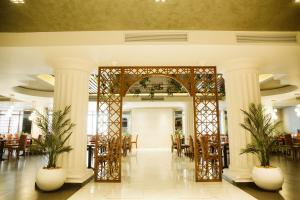 a lobby with columns and tables and chairs at Pyramisa Suites Hotel Cairo in Cairo
