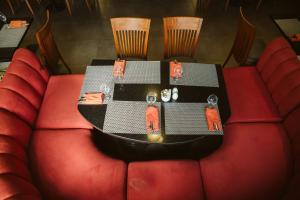 a table in a room with red chairs at Pyramisa Suites Hotel Cairo in Cairo