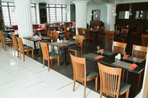 a dining room with tables and chairs in a restaurant at Pyramisa Suites Hotel Cairo in Cairo