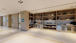a large room with wooden shelves in a building at Melia Sitges in Sitges