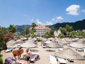 un grupo de personas en una playa con sombrillas en Fortuna Beach Hotel, en Marmaris