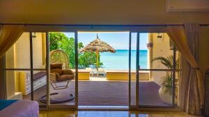 a room with a view of the ocean at Golden Palm Boutique Zanzibar in Zanzibar City