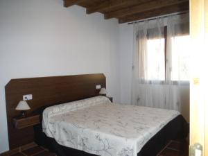 En eller flere senge i et værelse på El Rincón de los Riveros