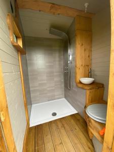 a small bathroom with a shower and a sink at Beautiful Rural Yurt with Wood Fired hot tub 