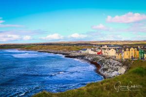 a town on the shore of a body of water at Ocean Breeze Apartment in Lahinch