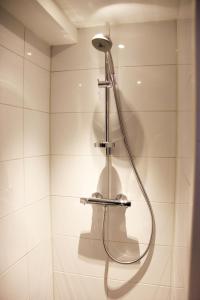 a shower with a shower head in a bathroom at House of Freddy in Amsterdam