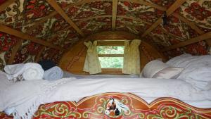 a large bed in a room with a window at Islay Westcote Glamping in Hawick