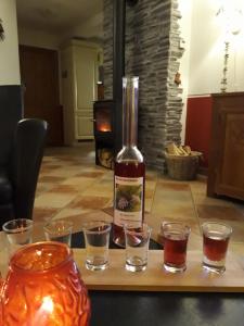 a bottle of wine sitting on a table with glasses at Ferienhaus Aloisia in Sankt Michael im Lungau