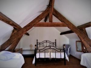 a bedroom with a bed in a attic at 1 Bedroom Tranquil Cottage Fishing by the lake in Bommiers