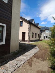 a house with a driveway next to a building at Morena in El Chalten