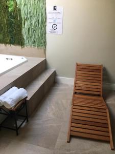 a bench in a room with a sink and a table at Absolut Confort Suites in Atalaia Velha +44 photos