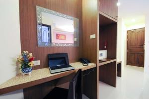 a room with a desk with a laptop computer on it at Royal Express Inn in Bangkok