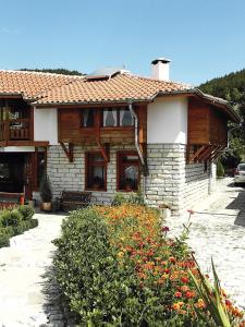 a large house with a roof at Zhivka House in Glavatartsi