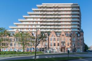 a large building in front of a street at Zongericht appartement met zicht op de jachthaven in Ostend