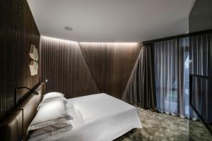 
a room with a white bed and a white rug at Amberton Green SPA Druskininkai in Druskininkai
