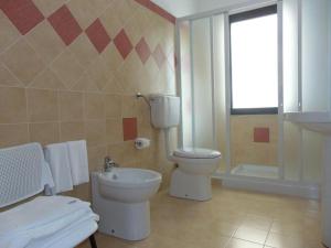 a bathroom with a toilet and a sink at Tus'Hotel in Castel di Tusa