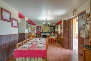 un comedor con una mesa larga con platos. en 5 bedrooms villa with private pool enclosed garden and wifi at Archidona en Archidona