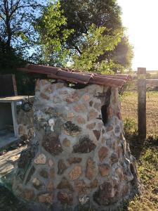 a stone oven with a roof on top of it at 6 bedrooms house with private pool and enclosed garden at Burguillos de Toledo in Burguillos de Toledo