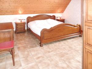 a bedroom with a wooden bed and two night stands at Appartement de 3 chambres avec jardin amenage et wifi a Epfig in Epfig