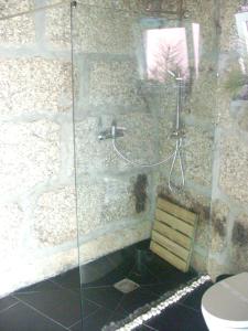 a bathroom with a glass shower with a toilet at Charming House in Santa Eulalia, perfect for 18 guests in Santa Eulália
