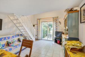 a room with a staircase and a room with a bed at Maison d'une chambre avec piscine partagee terrasse amenagee et wifi a Valras Plage in Valras-Plage