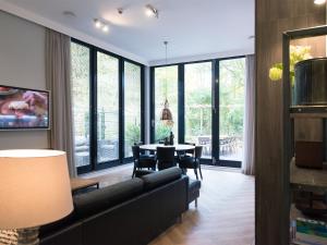 a living room with a couch and a table at Park Central Executive in The Hague