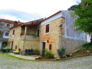 an old stone house with a cobblestone street at 3 bedrooms house with shared pool garden and wifi at Porto de Mos in Porto de Mós