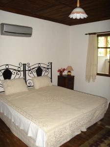a bedroom with a bed with a white comforter at Begonville Villa in Koycegiz