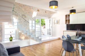 a living room with a glass staircase in a building at Elegant villa in Podgora with private pool and sea view in Podgora