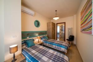 En eller flere senge i et værelse på Blue Moon - Via Torre del Lebbroso Apartments