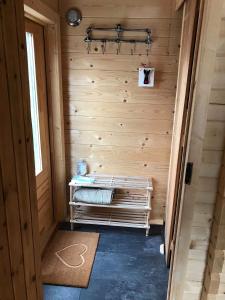 a sauna with a bench in a wooden wall at Off Grid Hideaway on the West Coast of Scotland in Blairmore