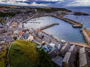 an aerial view of a coastal town with a harbor at The View 3-Bed Cottage Findochty Buckie Moray in Findochty